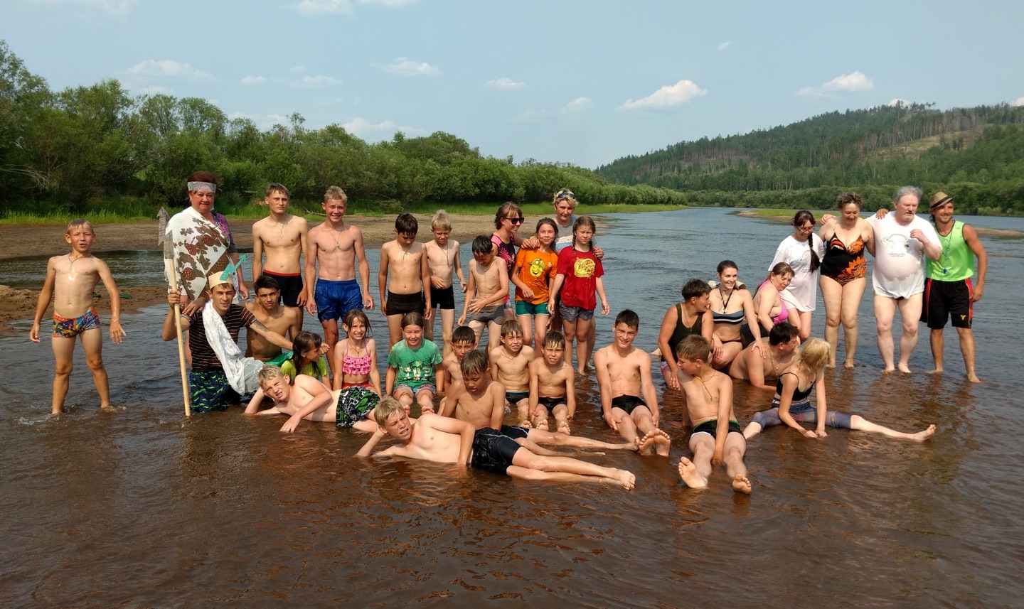 group of swimmers in the shallows of a river