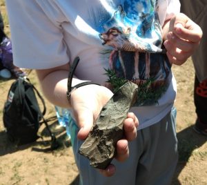 stone axe held by a child