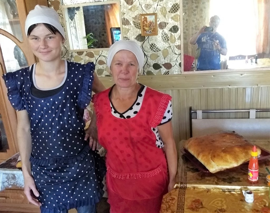 younger and older woman in aprons