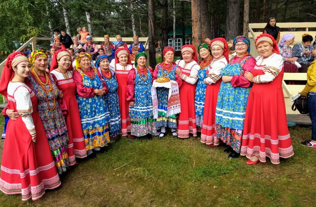 ladies in old Russian garb posing for the camera