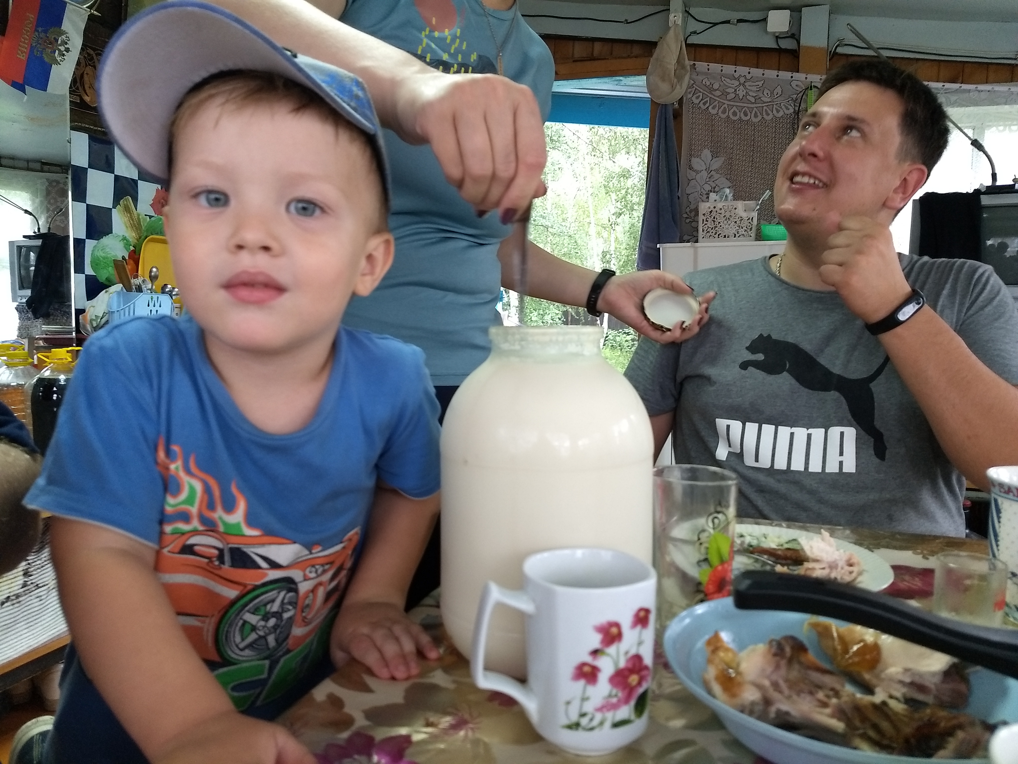 boy at table with a big jar of milk